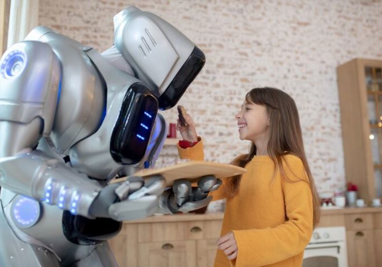 Girl is testing a robot by providing the food to it.
